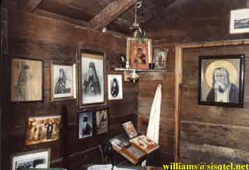 The icon corner, where one may observe icons of Christ, the Theotokos, Blessed Xenia, St. Seraphim, the Cross, St. Herman, Sts. Methodius and Cyril - Copyright  The Blessed Seraphim Hermitage